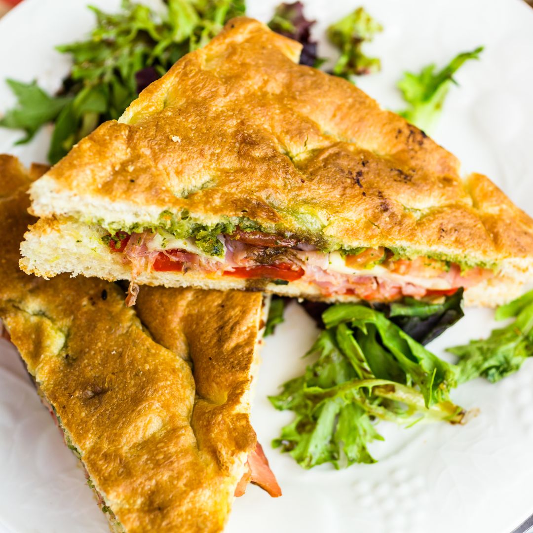 Olive us LOVE this Italian Focaccia sandwich! Bursting with flavor from a blend of olives and capers, this meaty sandwich will satisfy your hunger!  #focaccia #heartysandwiches #olives #easyrecipes #flavor #italiansandwich #delish #olive