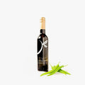 Bottle of Baklouti Pepper Olive Oil with fresh peppers on white background. 