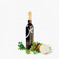 A bottle of Little Shaker Gourmet Balsamic Vinegar styled with fresh green parsley, a whole white onion, and a sliced brown onion on a clean white background.