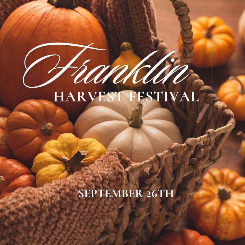 Promotional graphic for the Franklin Harvest Festival on September 26th, featuring a rustic woven basket filled with colorful autumn pumpkins and gourds.