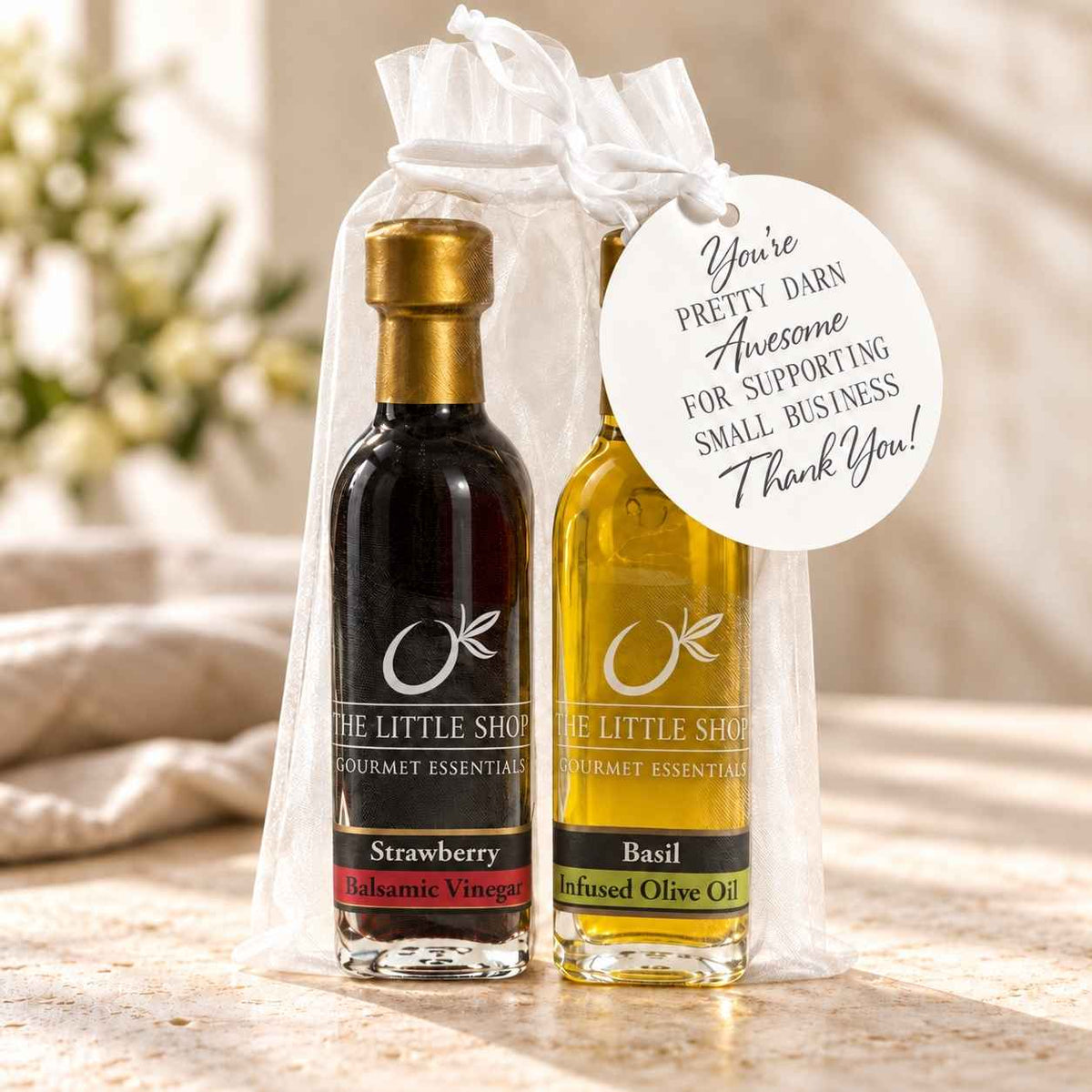 Gourmet olive oil and aged balsamic sampler gift set in an organza bag by The Little Shop of Olive Oils.