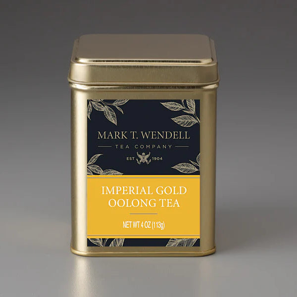 Gold tea canister with 'Mark T. Wendell Tea Company' label on a gray background