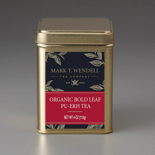 Gold tea canister with a red label on a gray background for Organic Bold Leaf Pu-erh Tea