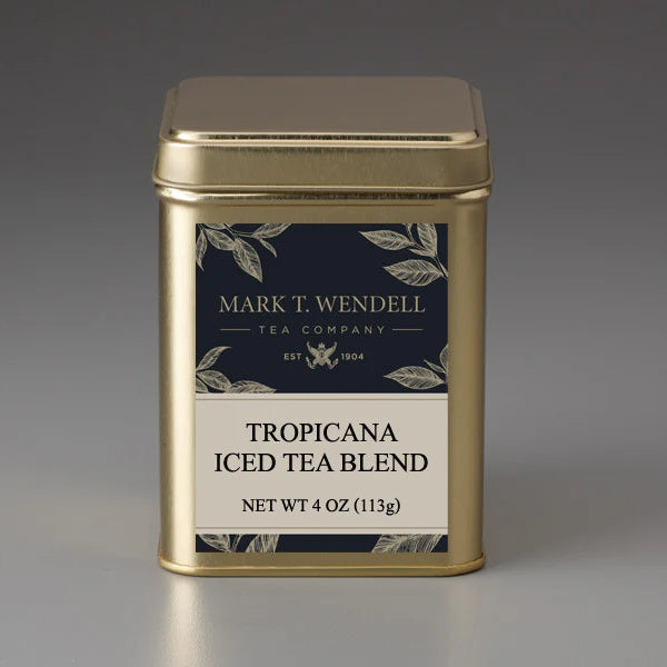Gold tea canister labeled 'Barbados Fruit Tisane' by Mark T. Wendell on a gray background