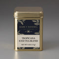Gold tea canister labeled 'Barbados Fruit Tisane' by Mark T. Wendell on a gray background